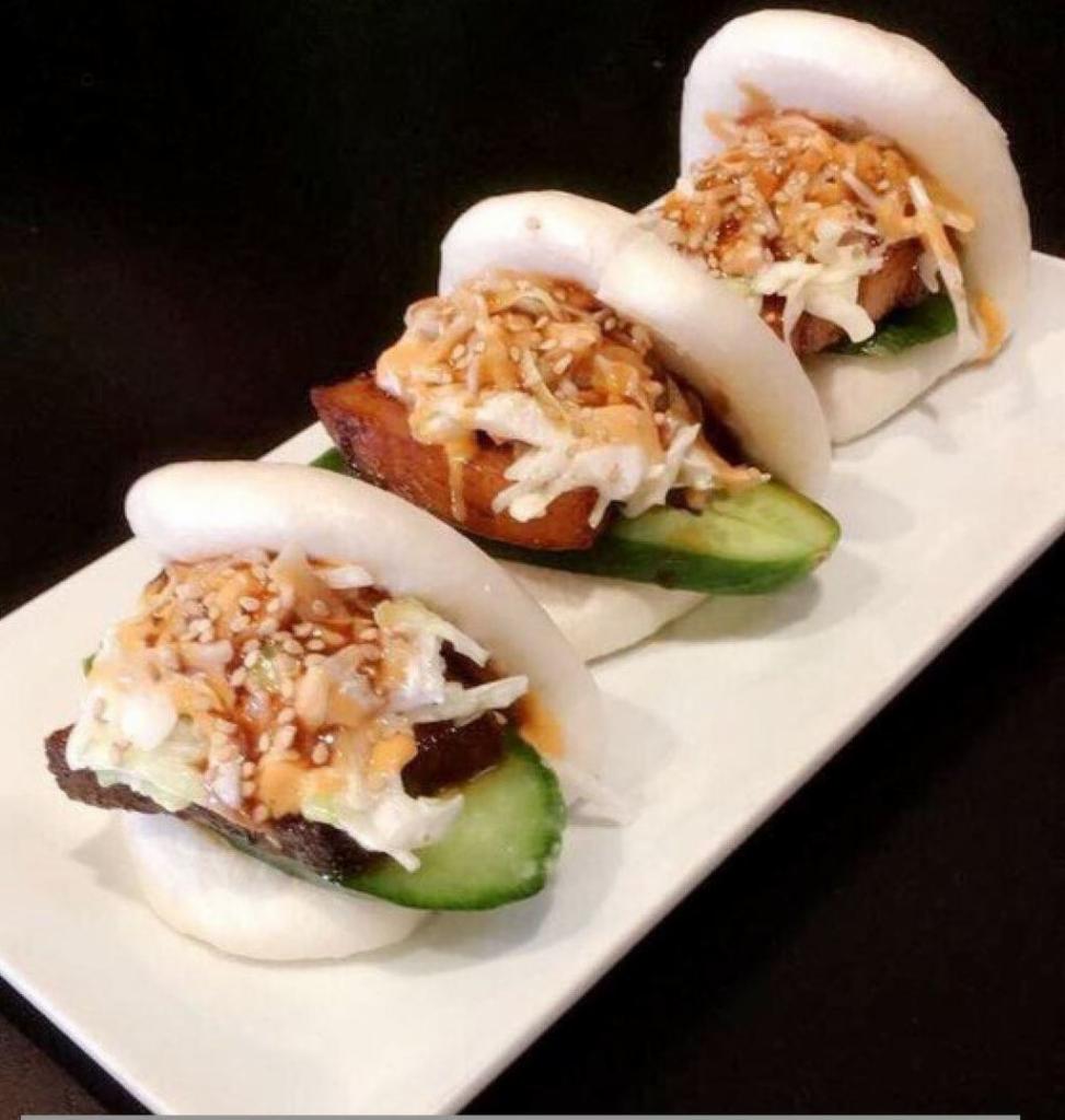 Pork Buns · Slice of savory pork belly dressed with Bonchon Soy Garlic Sauce, topped with cucumbers, coleslaw, spicy mayo, and katsu sauce. 3 per order.  790 Cal.