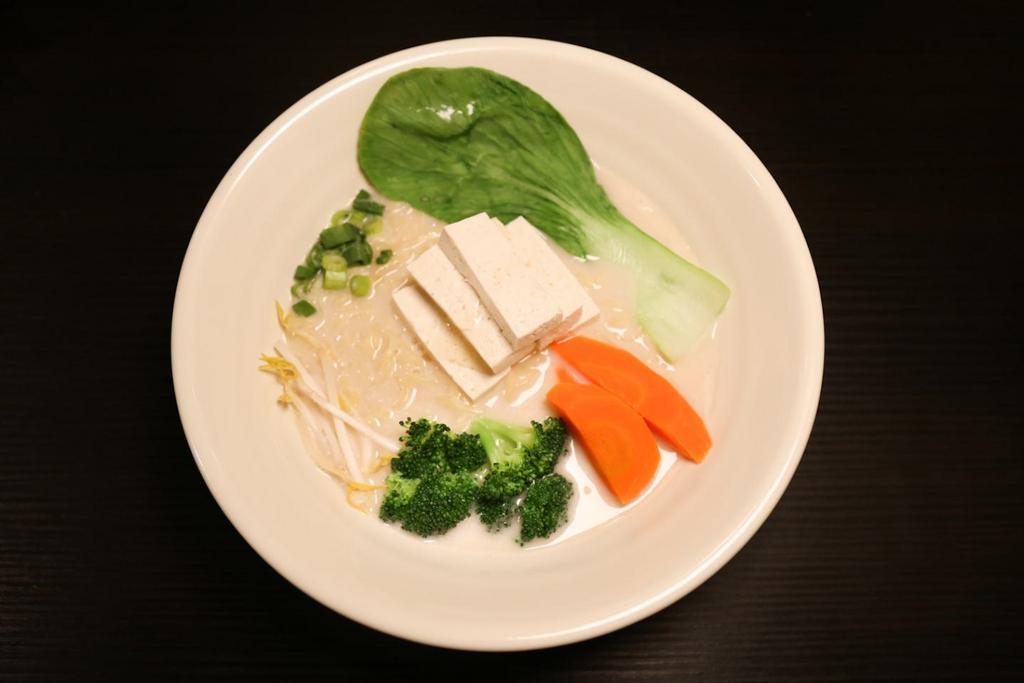 Creamy Veggie Ramen · Vegetable soup. Yellow egg noodles, tofu, broccoli, carrot, bean sprouts, bok choy, green onion, onion oil.