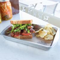 BLT Sandwich · Butcher cut smoked bacon, romaine and tomatoes with truffle aioli stacked high on a toasted ...