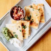Chicken Quesadillas · Corn tortilla stuffed with cheese and chicken. Served with guacamole sauce, cream and mild s...