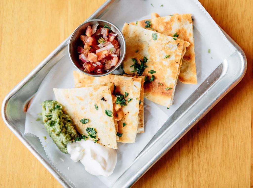Chicken Quesadillas · Corn tortilla stuffed with cheese and chicken. Served with guacamole sauce, cream and mild salsa.
