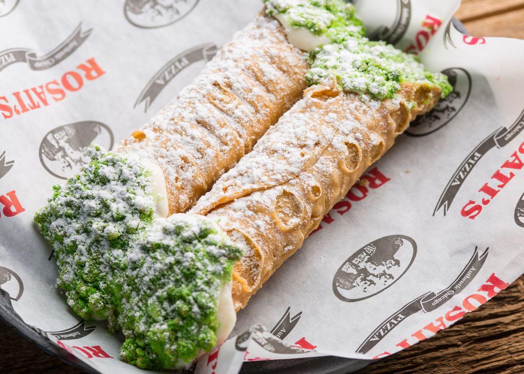 2 Cannoli · Crisp Sicilian pastry shells filled with sweetened ricotta and chocolate chips dipped into pistachios and covered with powdered sugar.