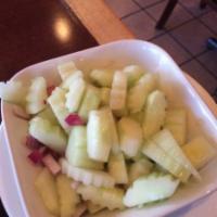 Cucumber Salad · Cucumber, red bell peppers and red onions in a sweet vinaigrette dressing.