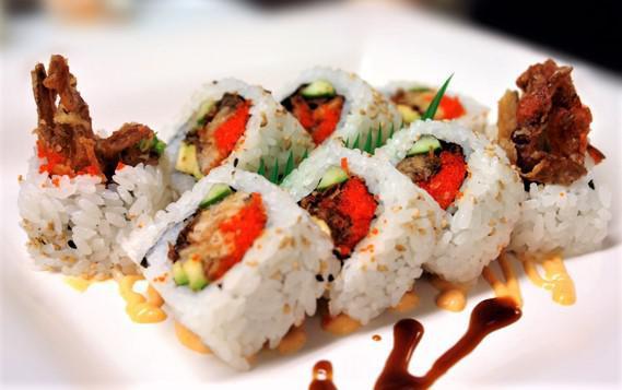 Soft Shell Maki · Uramaki with soft shell crab, avocado, masago, green onions and topped with our spicy sauce and teriyaki sauce.