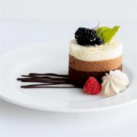 Triple Chocolate Mousse Cake · Layers of dark, milk and white chocolate mousse, topped with a brown sugar & chocolate merin...