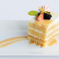 La Jolla Groves Lemon Cake · Artisan layered white cake, whipped lemon custard, topped with strawberry meringue and candi...