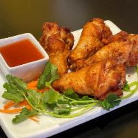 Bistro Wings (4) · Deep Fried Seasoned Chicken Wings, served with fried onion and house-made tamarind sauce.