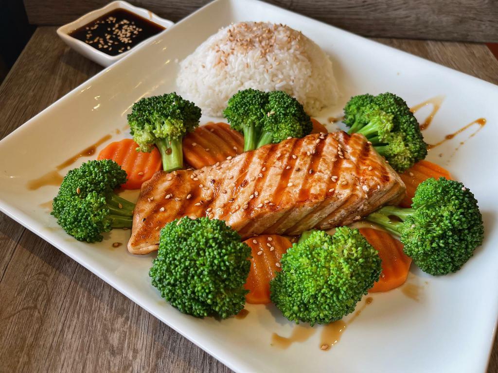 Grilled Teriyaki Salmon · Grilled salmon fillet topped with in-house special teriyaki sauce served with steamed broccolis, carrots, and a scoop of jasmine rice.
