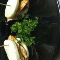 11. Salmon Bun · 2 pieces. Salmon, teriyaki, spring mix, onion, cabbage and sesame seasoning.