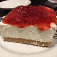 Greek Style Cheesecake · Greek yogurt and cream cheese with graham cracker crust topped with raspberry jam.