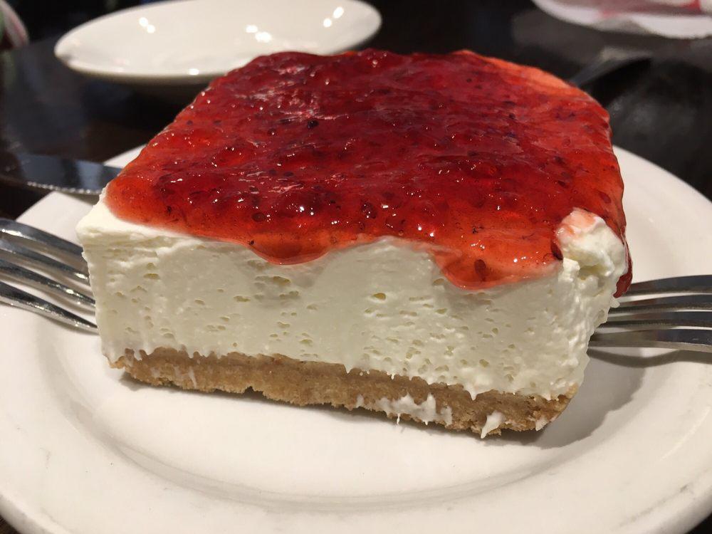 Greek Style Cheesecake · Greek yogurt and cream cheese with graham cracker crust topped with raspberry jam.