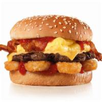 The Breakfast Burger™ · Charbroiled All-Beef Patty, Egg, Bacon, American Cheese, Hash Rounds®, and Ketchup on a seed...