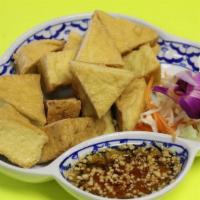 Tofu Tod · Golden brown tofu served with sweet and sour sauce mixed with ground peanut.