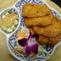Tod Mun Pla · Deep fried fish cake served with cucumber salad.