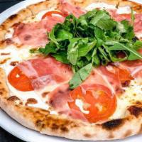 Prosciutto Pizza · Mozzarella, tomatoes, prosciutto San Daniel and fresh arugula. Baked in our brick oven with ...