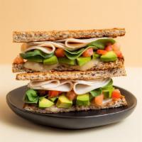 The Cali Sandwich · Toasted Sprouted Bread, Avocado, Provolone Cheese, Chicken, Spinach, Tomato, Garlic & Himala...
