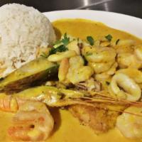 Pescado a Lo Macho · Shrimp, squid and scallops in a spicy, creamy aji Amarillo and garlic shellfish sauce on top...