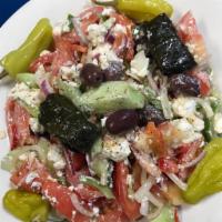 Horiatiki (Greek Salad) · Vine ripe beef steak tomatoes, onions, cucumbers, peppers, feta cheese, olives, oregano and ...