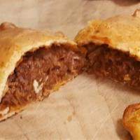 Beef Panca Empanada · Cubed beef loin, simmered in a savory panca dried chili sauce and baked. Not spicy. Order ad...