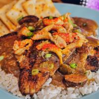 Catfish Tout · 2 blackened fillets on a bed of white rice, smothered with a mixture of gumbo, etouffee and ...