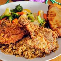 Pork Chops · 2 pork chops, blackened or fried, served with dirty rice and mixed vegetables, served with d...