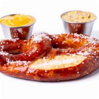 *Bavarian Pretzel* · German pretzel served with whole grain mustard and nacho cheese sauce.