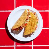 Crunchy Taco · House fried corn tortilla shell. Choose between  ground beef or chicken. It comes with tomat...