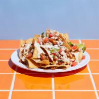 Nachos · Queso, shredded cheese, sour cream, fresco cheese, choice of meat, and pico.