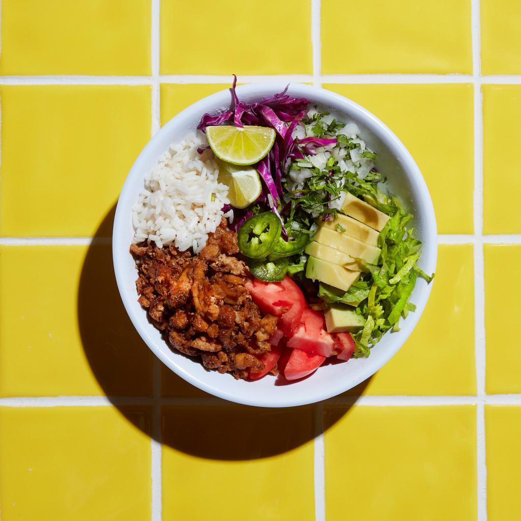 Tiki Bowl · Bowl filled with house steamed rice, choice of protein & sauce. Garnished with purple cabbage, lettuce, black beans, guacamole, jalapeno, onion, lime, cilantro, and tomato.