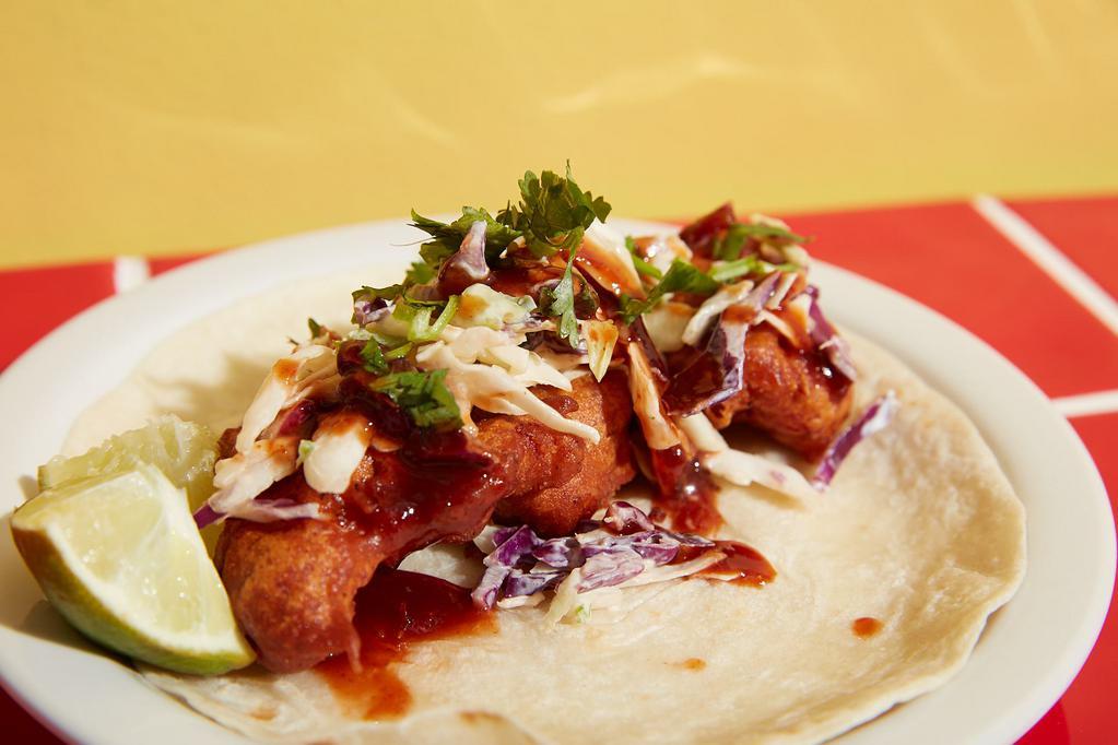 Thai Fried Chicken Taco · All white meat chicken tempura hand battered to order. Sour cream, purple cabbage, and jalapeño slaw. Spicy Thai chili sauce on a flour tortilla. 
