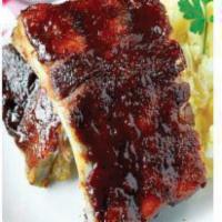 1/2 Baby Back Rib Combo · 1/2 baby back rib serve with choice of rice or french fries and a side salad. With BBQ sauce.
