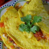 Tex-Mex Omelette · Sauteed veges , hot chili, cheddar cheese top with avocado and Gallo de ajo.