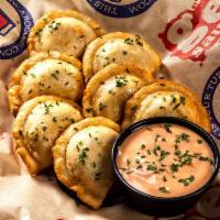 Amish Pierogies · Traditional real cheese and potato dumplings, house-made sweet chili sour cream.