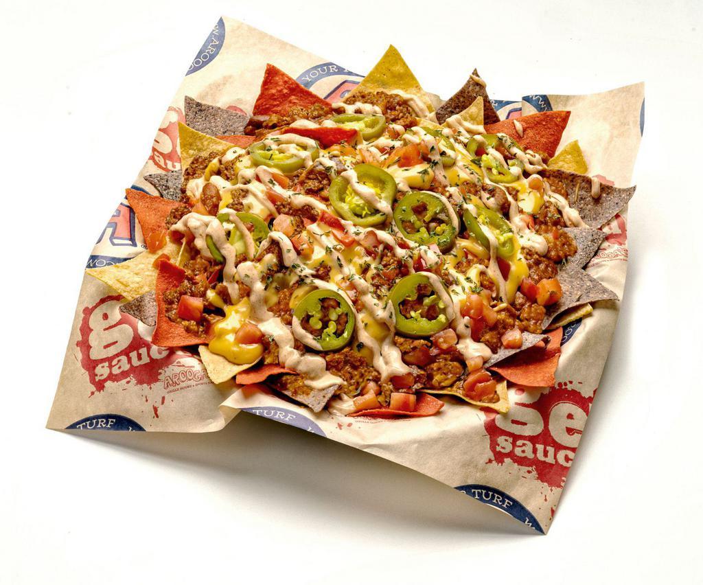 Impossible Chili Nachos · Non-GMO tortilla chips layered with ImpossibleTM Chili, Fat Tire® beer cheese & cheddar/ mozzarella cheeses, jalapeños, chopped tomatoes, chipotle sour cream.