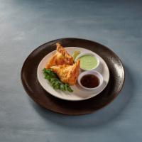 Samosa · A triangular savory pastry filled with your choice from below. Served with tamarind chutney.