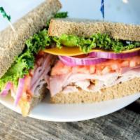House of Bread Club Sandwich · Turkey, ham, cheddar, lettuce, tomato, red onion, mustard and mayo.