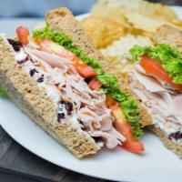 Cranky Turkey Sandwich · Turkey, cream cheese, dried cranberries, lettuce, tomato, red onion and mayo.