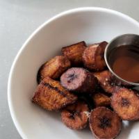 Sweet Fried Plantains · Sweet fried plantains, sugar dusting, and local maple syrup. Gluten Free. Vegan. Nut Free.