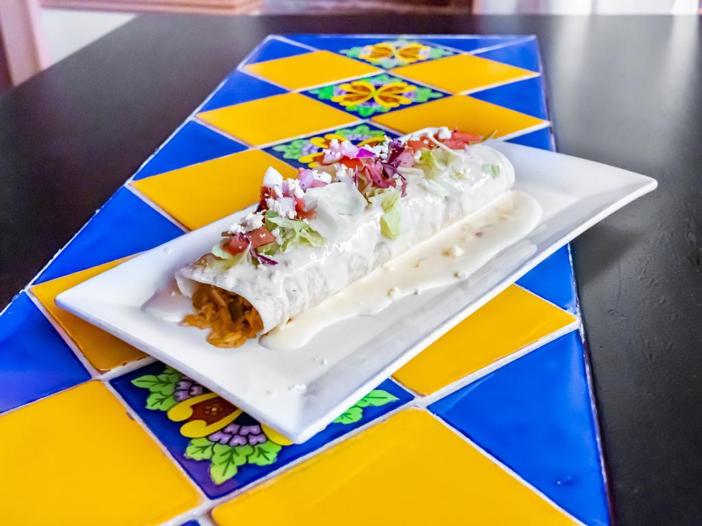 Casa Blanca Burrito · Choice of shredded chicken, ground beef, pork carnitas or barbacoa. Stuffed with rice and re-fried beans, Topped with enchilada style sauce, pico de gallo. Cotija cheese, lettuce, sour cream and guacamole.
