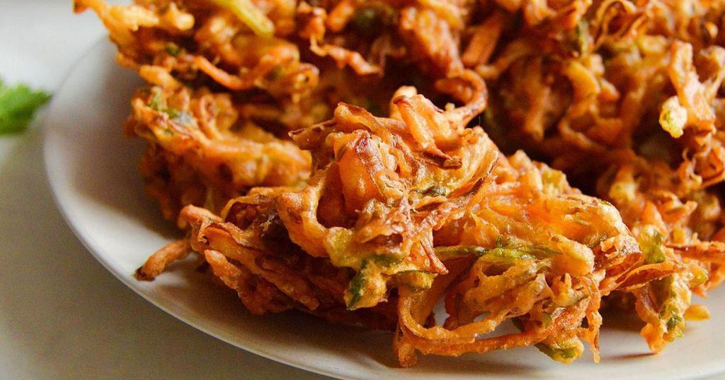 18. Pakoras · Assorted vegetables fritters fried with chick peas flour and spices. Vegan.