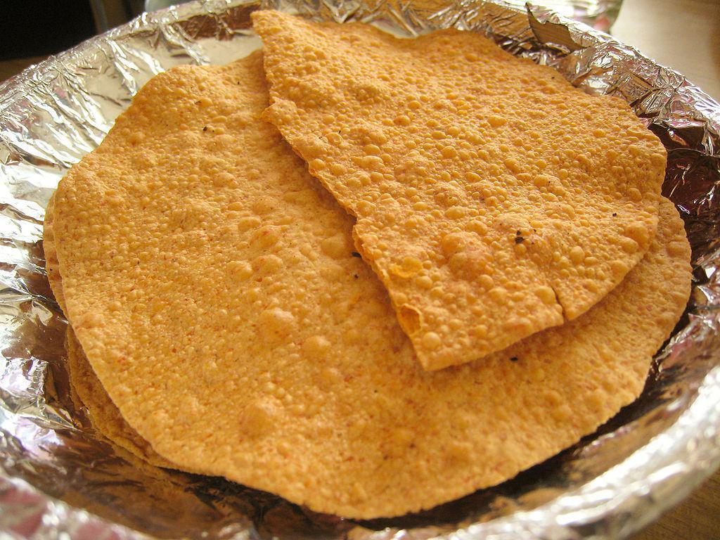 23. Papadom · Thin lentil cracker with black pepper, sea salt and spices. Vegan.