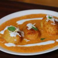 84. Malai Koftas · Veggie balls cooked in a mild curry sauce and finish with almond cream.