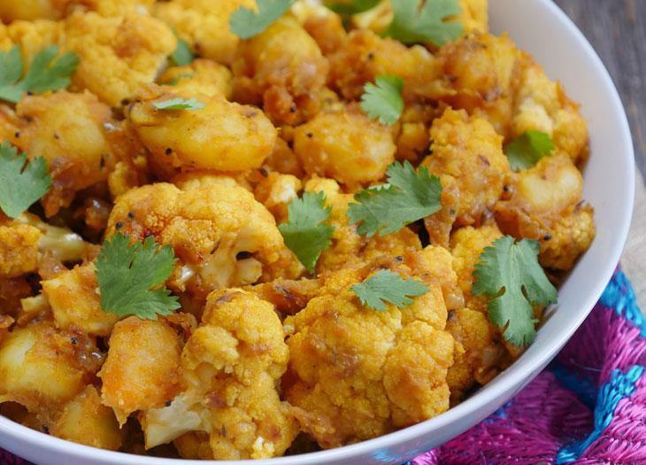 89. Aloo Gobi · Potato and cauliflower cooked with cumin, ginger and garlic with or without green peas.
