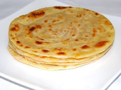 106. Plain Paratha · Layered white flour bread fresh baked in tandoor.