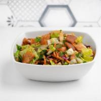Fattoush Salad · Lettuce, parsley, shredded carrots, cucumbers, tomatoes, topped with fried pita chips, and h...