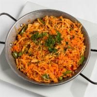 Arroz con Pollo · Served with yellow rice, sauteed chicken, peppers, carrots and peas.