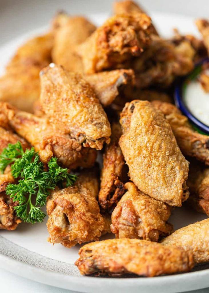 Chicken Wings · Golden fried wings served with a spice mixed sauce.