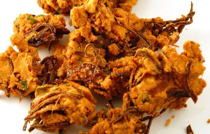 Pakora · Mix of fresh herbs, gram flour and greens with onions, deep fried until golden brown. Served with mint chutney.
