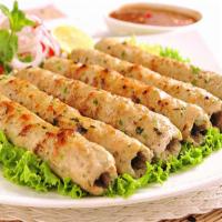 Chicken Seekh Kabab · Minced chicken stuffed with cheese and fresh herbs, grilled tender and juicy.