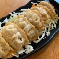 Gyoza · Potstickers willed with pork and vegetables.